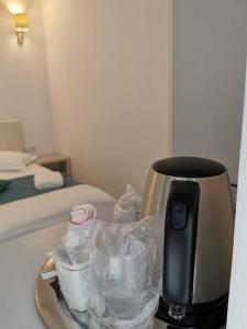 a coffee maker on a tray next to a bed at Casa Loro in Eforie Sud