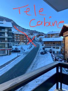a view of a street in a city with a red cross at Clair Vue A3 near Télécabine by Jolidi in Nendaz