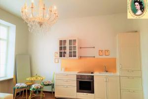 a kitchen with a chandelier and a stove top oven at Sisi-Schloss Rudolfsvilla - Duo in Reichenau