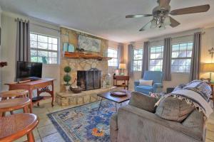 a living room with a couch and a fireplace at Arbor Creek in Wimberley