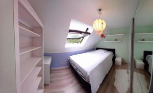 a small bedroom with a bed and a window at Les prussiens in Wavre +4 photos