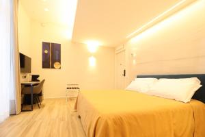 a bedroom with a large bed and a desk at Municipio Luxury Suite in Naples