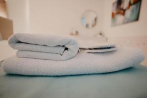 three towels sitting on top of a bathroom counter at Hai Hotel in Larnaca