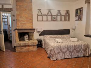 a bedroom with a bed and a fireplace at Il Torrione in Castiglione del Lago