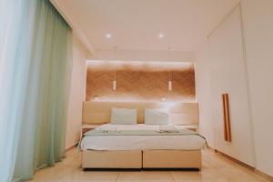a bedroom with a large bed in a room at Hai Hotel in Larnaca