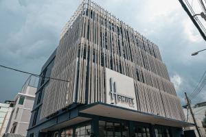 a tall building with a sign on the side of it at HOMITEL Bangkok in Bangkok