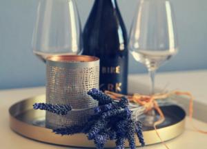 a table with a bottle of wine and two glasses at Marina Guesthouse in Korčula