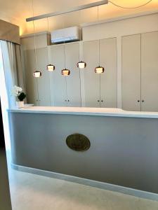 a bathroom with a mirror and a sink at Hotel London in Viareggio