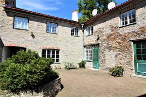 a brick building with green doors and a courtyard at Tallinn City Apartments Old Town Toompea in Tallinn