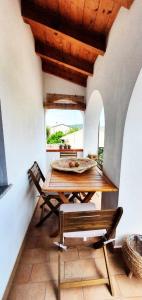 a dining room with a wooden table and chairs at A casa di Anna in Galtellì
