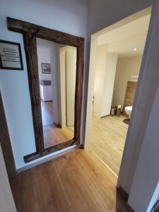 a hallway with a mirror and a hallway with a room at Haus Nothnagl in Spitz