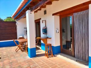 a patio of a house with a table and a television at chabouco 2 (Mien) in Aljezur