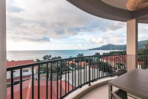 a balcony with a view of the ocean at Villa Rousseau in Victoria