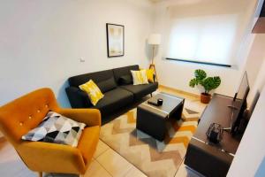 a living room with a couch and a table at Donoso Cortes Apartment - Alicante in Alicante