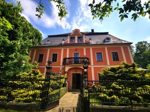 an orange house with a gate in front of it at Dom wakacyjny Chillout Rock in Lwówek Śląski