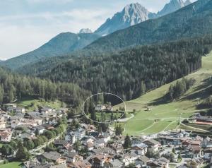 a town in a valley with mountains in the background at Hotel Villa Waldheim in San Candido