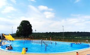 a large swimming pool with people playing in it at Dom wakacyjny Chillout Rock in Lwówek Śląski