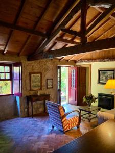 a living room with a chair and a table at Quinta da Boa Viagem in Viana do Castelo