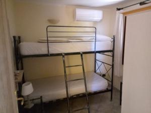 a room with three bunk beds in a room at Fiordaliso Aurora in Olbia +23 photos