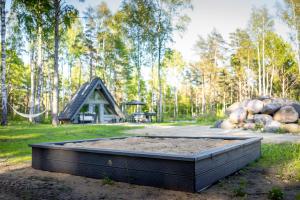 a large bed of dirt in front of a cabin at Nordicstay Noarootsi Saunahouse in Paslepa