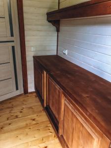 a wooden cabinet in a room with wooden floors at Апартаменти у Верховині in Verkhovyna