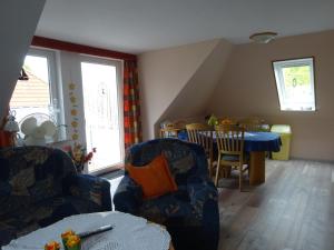 uma sala de estar com duas cadeiras e uma mesa em FeWo Elke em Esens