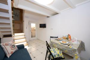 a dining room with a table and a blue couch at La dimora del nonno...nel cuore di Amalfi in Amalfi