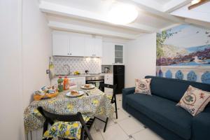 ein Wohnzimmer mit einem Tisch und einem Sofa in der Unterkunft La dimora del nonno...nel cuore di Amalfi in Amalfi