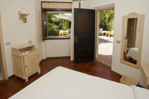 a room with a bed and a mirror and a door at Costa Dorada in Cala Gonone