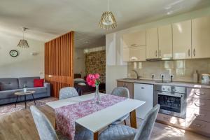 a kitchen and living room with a table and chairs at Stonehouse in Olives in Ulcinj