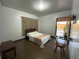 a bedroom with a bed and a desk and a window at Pousada do Lajes in Carolina +22 photos