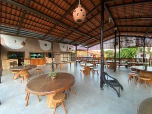 a restaurant with wooden tables and chairs and tables at Pousada do Lajes in Carolina