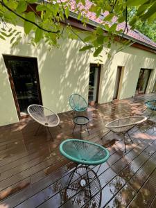 a patio with tables and chairs on a wooden deck at MYSTAY BERLIN Müggelheim in Berlin