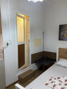 a small bedroom with a bed and a window at 9 Mai Central Studio in Sibiu