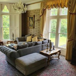 a living room with a couch and a table at Historic Manor House - Sleeps 16 - Pool & Hot Tub in Rochester