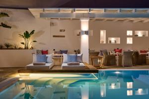 a pool in the middle of a room with couches at Stelia Mare Boutique Hotel in Naousa