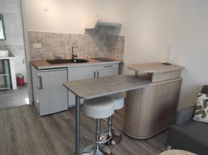 a small kitchen with a sink and a counter at appartement Anna in Parentis-en-Born