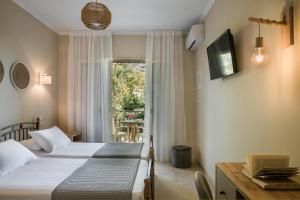 Ένα ή περισσότερα κρεβάτια σε δωμάτιο στο Irilena Hotel