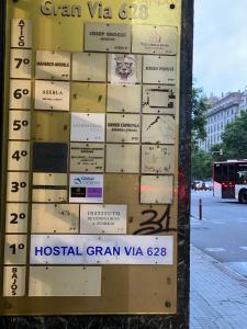 a sign for a hospitalgan vga on a street at Hostal Granvia 628 in Barcelona