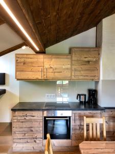 a kitchen with wooden cabinets and a stove at Hoamalm in Grossarl