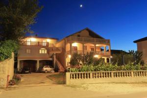a large house with a car parked in front of it at Francesca Apartment in Bibinje