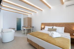 a hotel room with a bed and a desk at Vergina Beach Hotel in Agia Marina Nea Kydonias