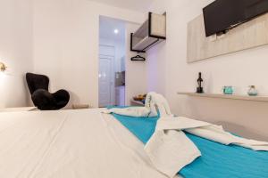 a room with a bed with towels on it at Stay Helios in Faliraki