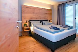 a bedroom with a large bed with a wooden headboard at moun10 urlaubswohnen in Garmisch-Partenkirchen