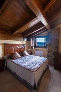 a bedroom with a large bed with a large window at Apartamentos Farrai llova 