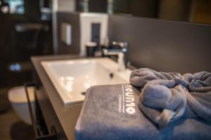 a bathroom with a sink and a towel on a counter at moun10 urlaubswohnen in Garmisch-Partenkirchen +106 photos