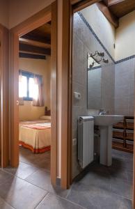 a bathroom with a sink and a bed at Apartamentos Farrai llova 