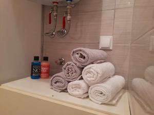 a pile of towels sitting on a shelf in a bathroom at King's Cave in Jajce +20 photos