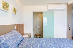 Postel nebo postele na pokoji v ubytování Loft aconchegante, vista mar lateral, vaga privativa