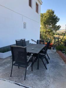 a wooden table and chairs on a patio at La Hermosa Vista in Alora